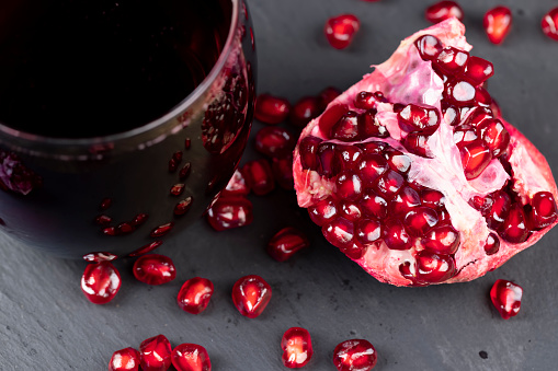 peeled red ripe pomegranate with red sweet grains, juicy pomegranate seeds of red color