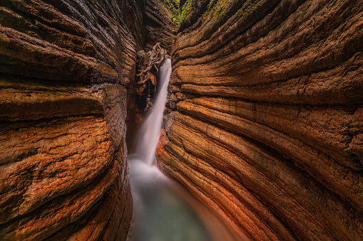 long exposure shot of hidden waterfall in small canyon