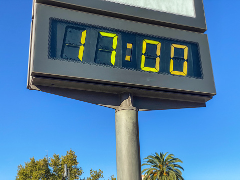 Low angle view of billboard showing 17:00 hours in the city of Valencia, Spain