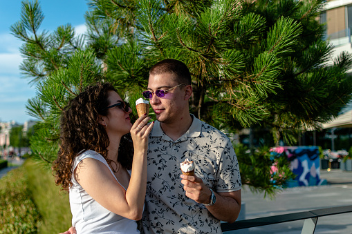 Becoming promenade sweethearts, the young couple shares sweet moments while strolling with ice cream in hand, celebrating their love