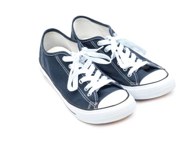 istock A pair of navy blue sneakers isolated on a white background. 1720425798