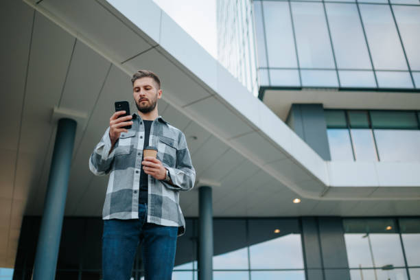 istock Cyber City Chronicles Confident Man with His Smartphone, copy space 1720438911