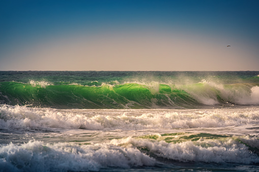 Beautiful green sunrise wave and cloudscape over the sea, sunrise shot