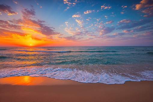 Tropical sunrise over ocean waves and beach shore, sea horizon  nature landscape