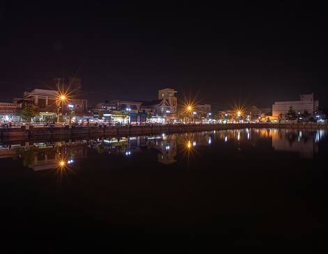 Go Cong town reflected by the Racetrack pond at night, Tien Giang province