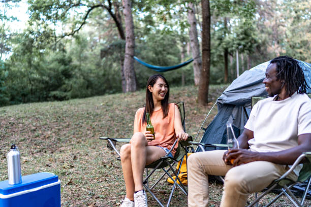 istock Friends camping, drinking beer and having fun 1720448044
