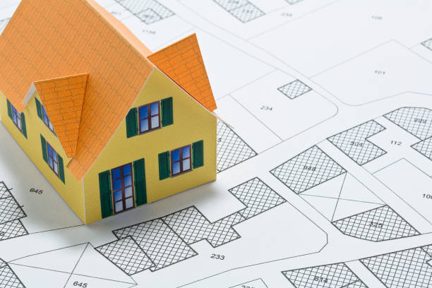 istock Cadastral map with buildings, building plot and free land parcel for house construction - building activity and permit concept with home model 1720449686