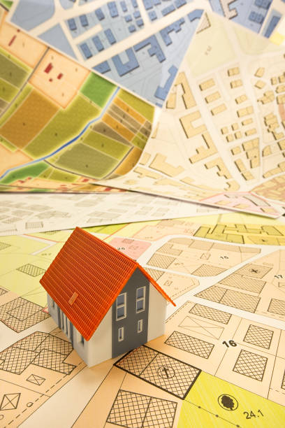 istock New home and free vacant land for building activity - Construction industry and building permit concept with a residential area, cadastral map, General Urban Planning and zoning regulations 1720459711