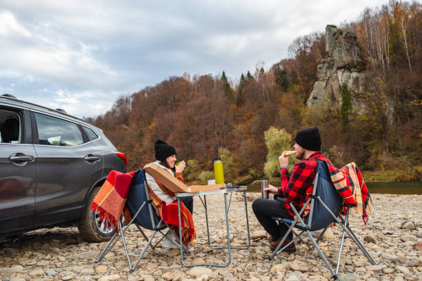istock couple having picnic at autumn mountain river 1720472480