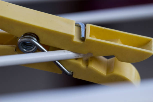istock A yellow clothespin with a white wire 1720485030