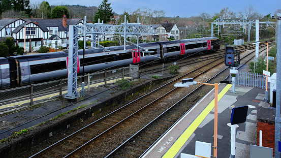 A station England UK. Diesel powered railway line in the English countryside. Station on a sunny day.