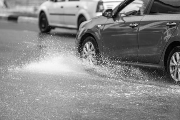 istock car rain puddle splashing water 1720500137
