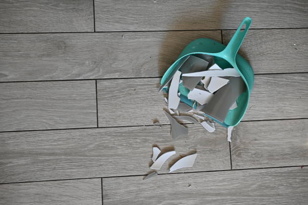 istock broken glassware on the floor is collected in a garbage scoop, the consequences of a quarrel are removed broken glassware on the gray floor 1720503767