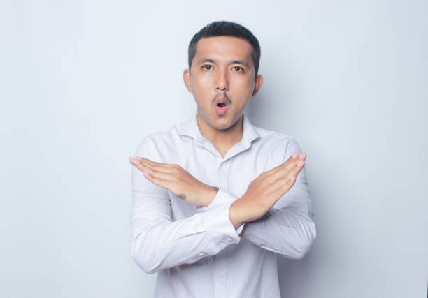 istock Concerned Indonesian Asian Man showing refusal sign. 1720511329