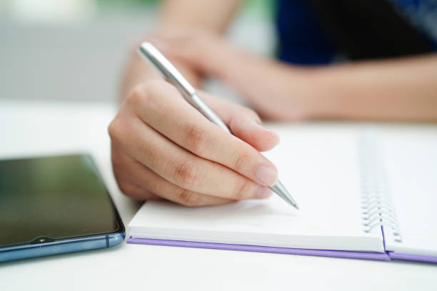 istock Asian teenage student write homework, study lesson for exam online learning education. 1720523836
