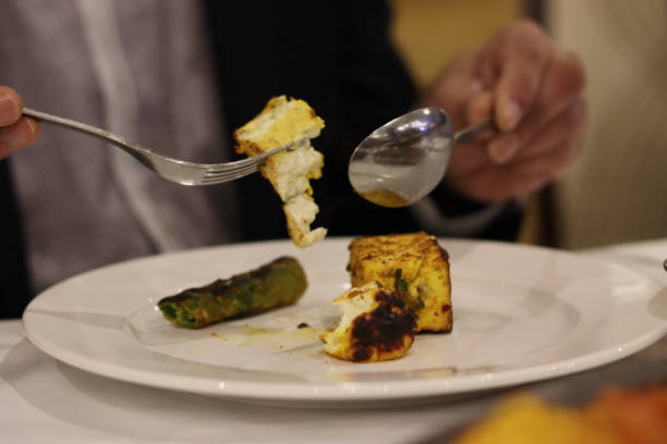 istock 1 Piece Roasted Paneer, 1 Piece Roasted Chilli, with a Spoon & Fork. Australia. 1720525474