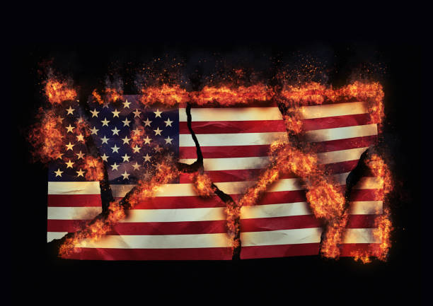 istock Burning American flag torn into pieces, representing US national disunity and conflict 1720536832