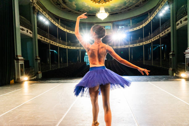 istock Young ballerina performing on a stage theater 1720545669