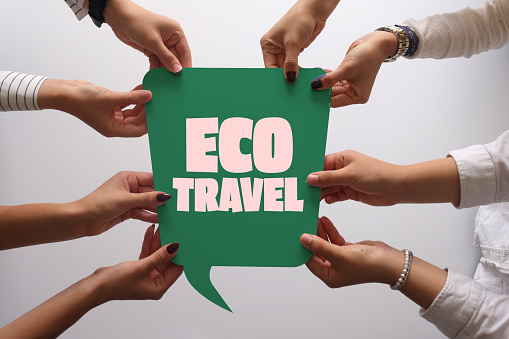 Group of people holding speech bubble with eco travel text