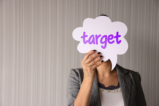 Woman holding speech bubble with target word