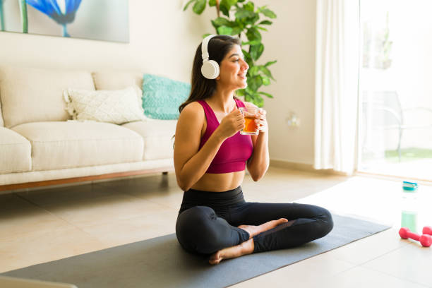 istock Hispanic woman with headphones practicing a meditation 1720581383