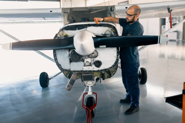 istock an aircraft mechanic is servicing the plane in the workshop 1720587096