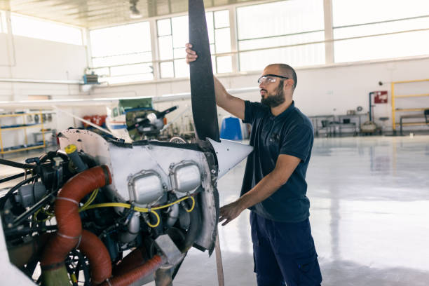 istock an aircraft mechanic is servicing the plane in the workshop 1720588758