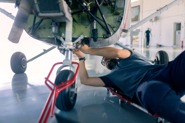 istock an aircraft mechanic is servicing the plane in the workshop 1720589356