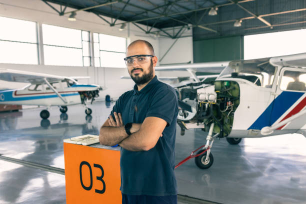 istock an aircraft mechanic is servicing the plane in the workshop 1720589889