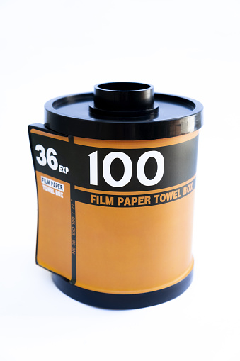 Camera film roll cartridge or 35mm filmstrip, equipment for photograph on white background.