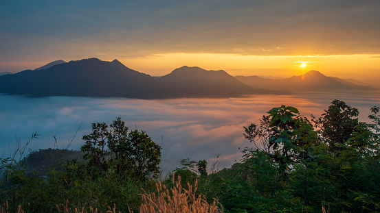 Sunrise with a sea of mist in the morning at Phu Thok. Chiang Khan District, Mueang Loei, Thailand