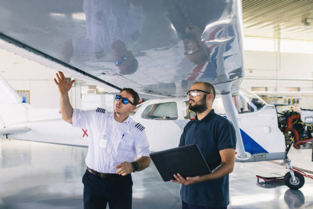 istock the aircraft mechanic and the pilot inspect the plane before take-off 1720597701