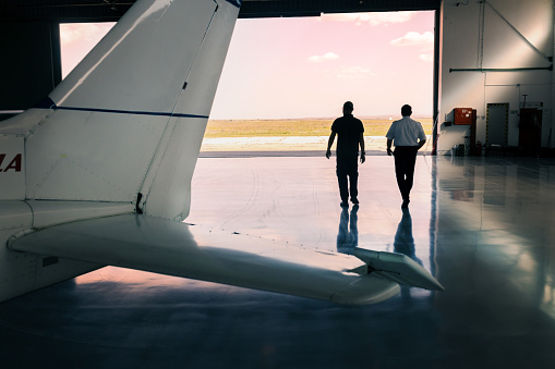 the aircraft mechanic and the pilot inspect the plane before take-off