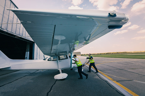the aircraft mechanic and the pilot inspect the plane before take-off
