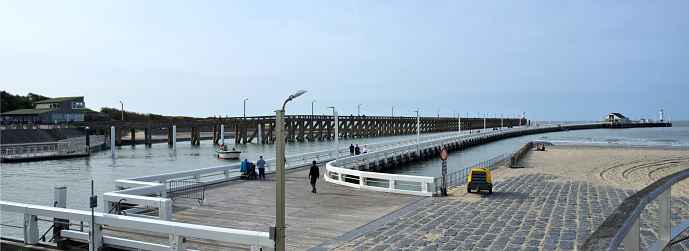 Blankenberge, West-Flanders, Belgium-September 30, 2023: tourists walking on the Oosterstaketsel pier in Autumn on a sunny Saturday
