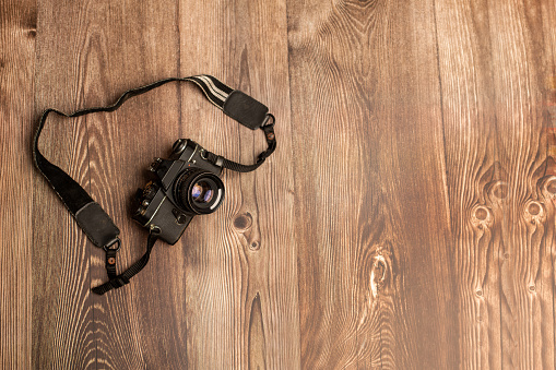 Old analogue SLR on wooden background