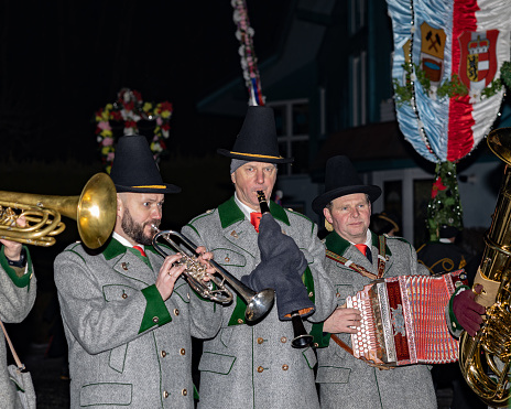 Gasteinertal, Austria – January 1, 2023: A group of musicians play early in the morning in the procession of perchts in the Austrian Gastein Valley
