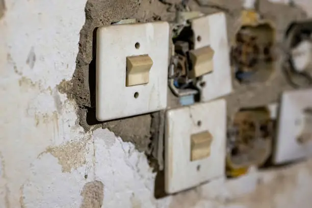 an old broken light switch in a lostplace in selective focus