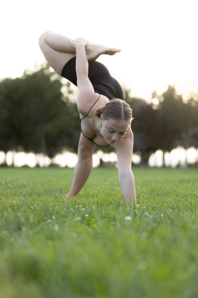 istock Flexible young woman is exercising on the outside. 1720648022