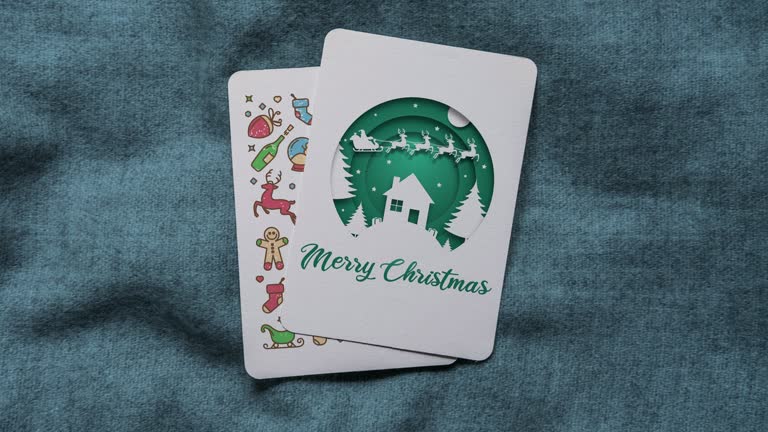 Green coloured paper cut style Santa Claus and flying reindeers animation with Merry Christmas text on vertical Christmas cards