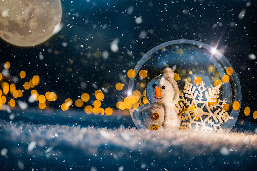 Snow Globe with Snowman inside it with Magic Snow Background