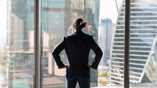 istock Back view successful African American businessman standing near panoramic window 1720679907
