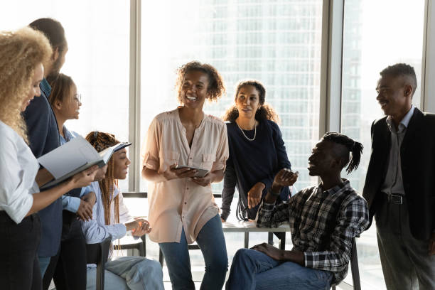 istock Happy diverse colleagues chatting at corporate meeting in modern office 1720680085