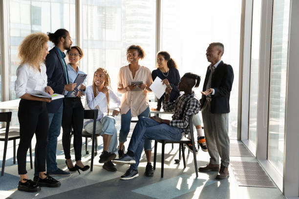 istock Happy diverse colleagues having fun at briefing, chatting in office 1720680436