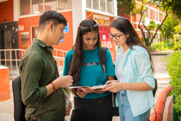istock Students discussing together on a book at university campus. 1720690653