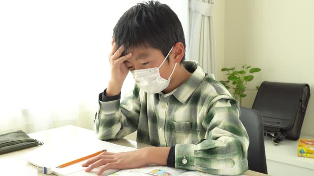 A boy gets sick while studying.