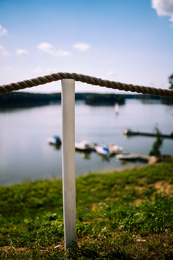 Ships on the calm water surface. Sailing on the lake or a river by the shore