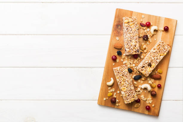 istock Various granola bars on table background. Cereal granola bars. Superfood breakfast bars with oats, nuts and berries, close up. Superfood concept 1720703748