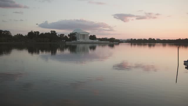 Thomas Jefferson monument and building at pond during evening