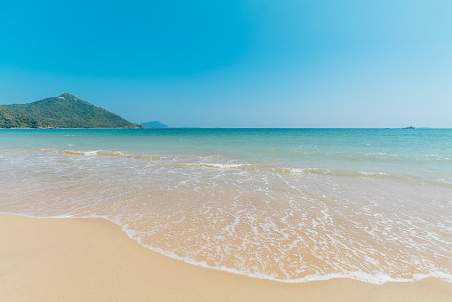 Serene scene of man walking on the beach in Ireland in summer